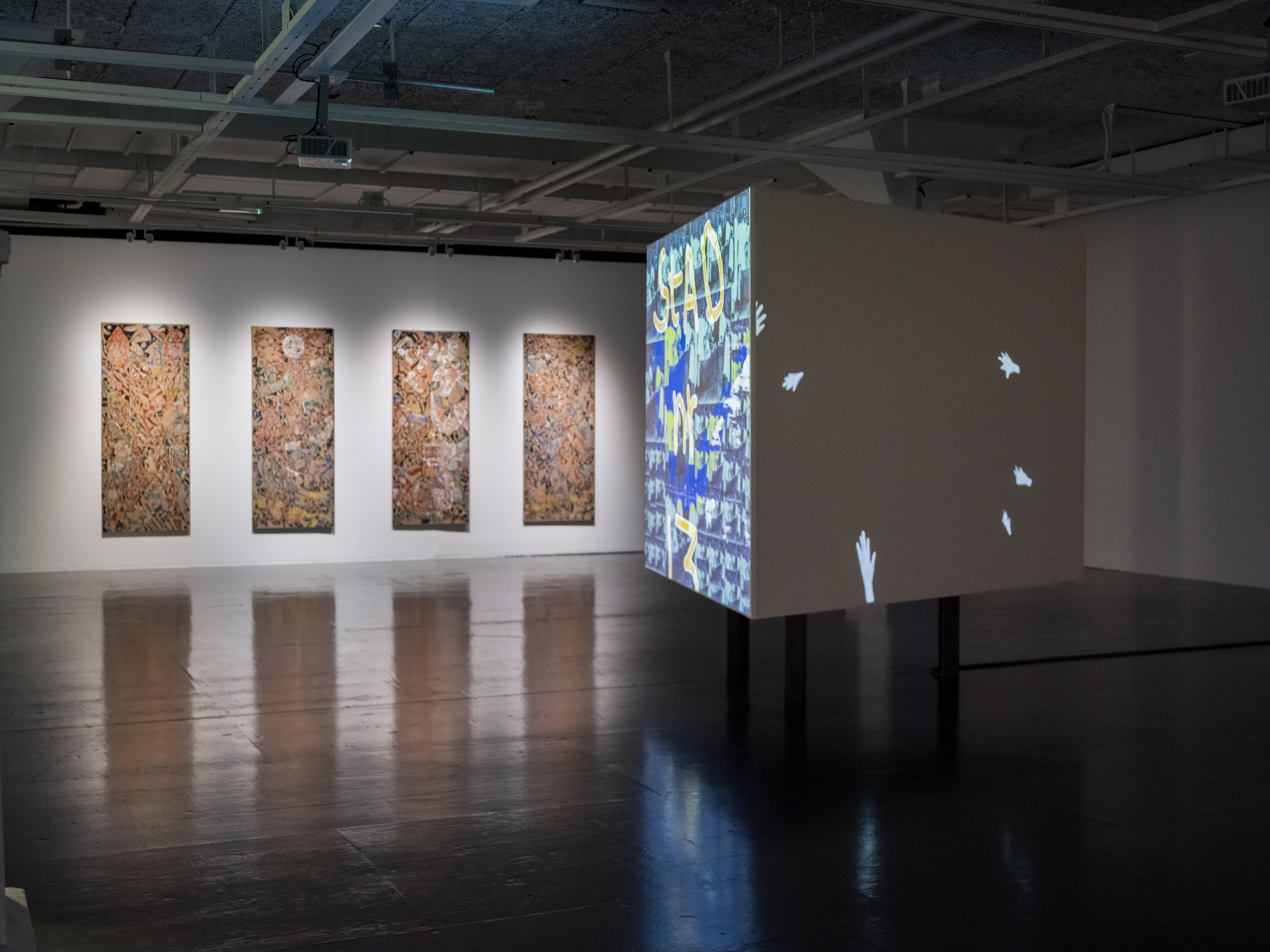 Photo of paintings by Wonga Mancoba och video installation by Salad Hilowle.